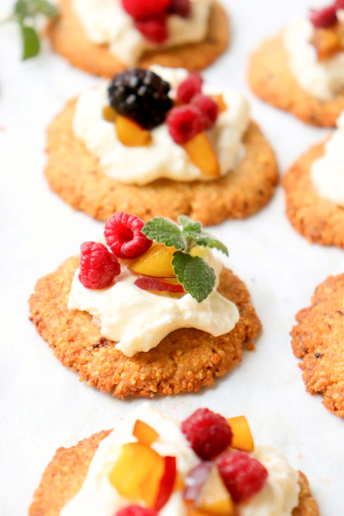 side view of sugar cookies topped with fruit.