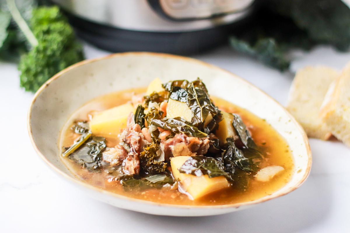 side view bowl of potato and kale soup.