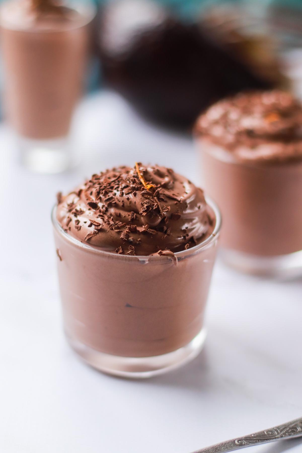 Chocolate pudding in a jar topped with chocolate shavings.