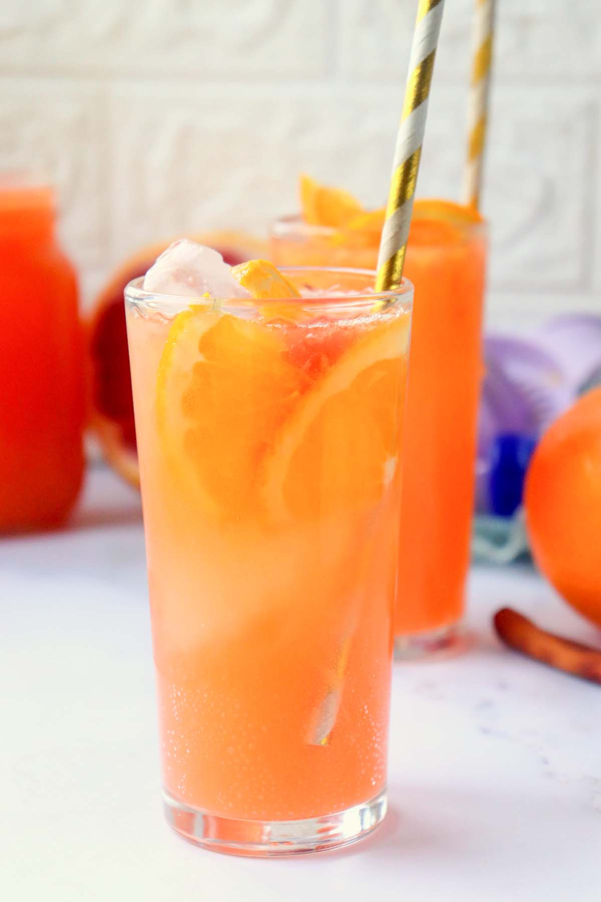 citrus punch in a glass with a straw.