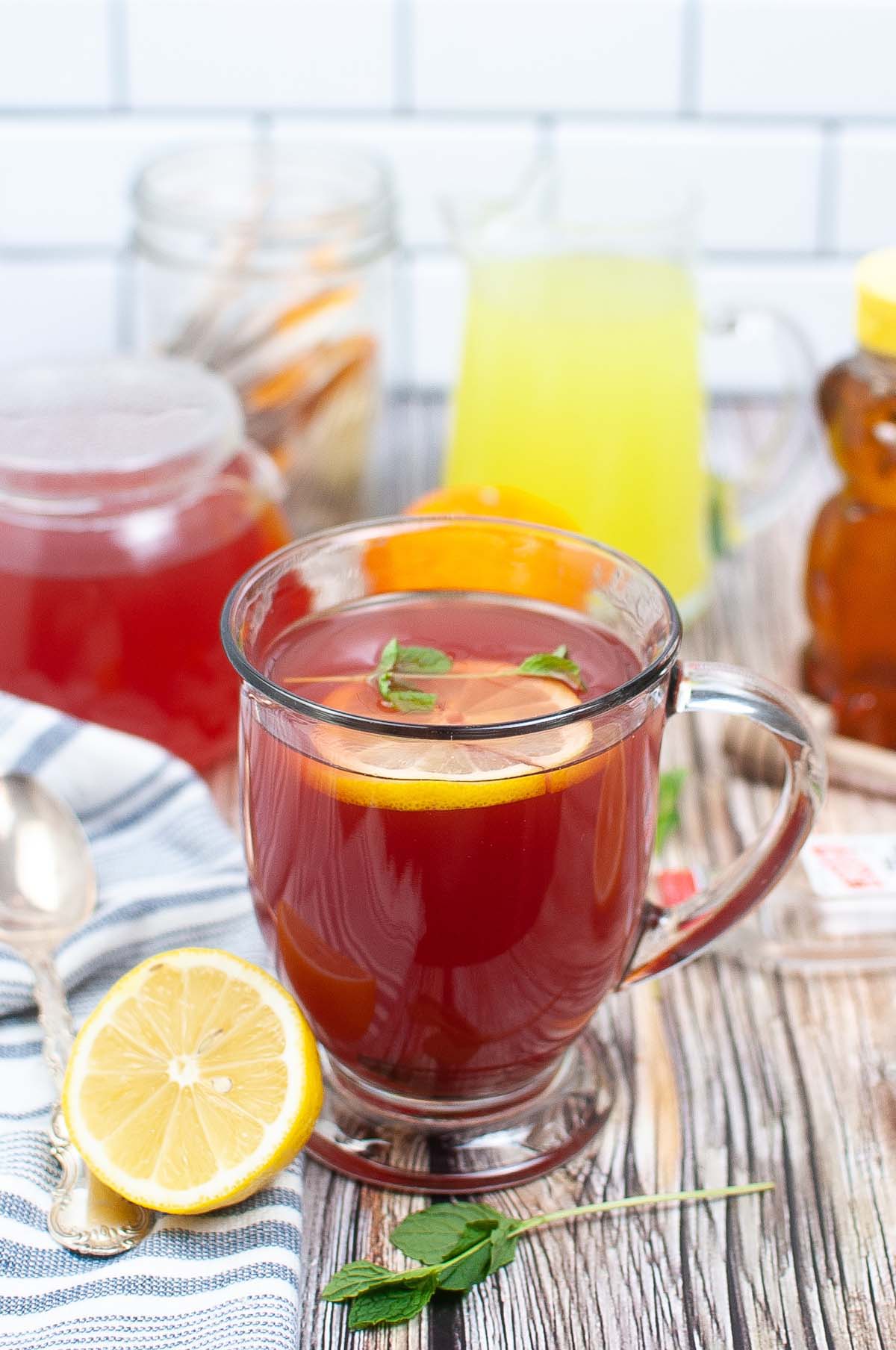 Tea in a glass mug on a wood table.