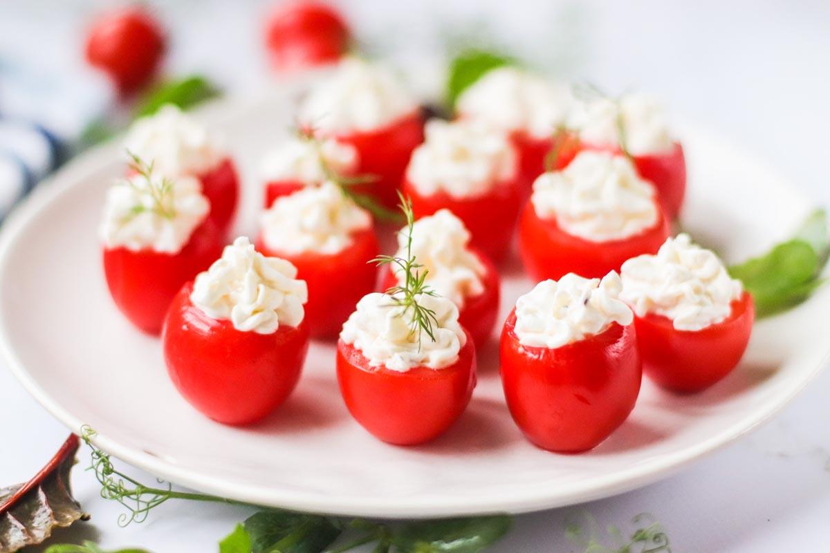 stuffed tomatoes on a white plate.