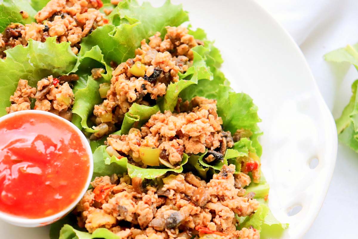 Lettuce wraps on a plate with dipping sauce.