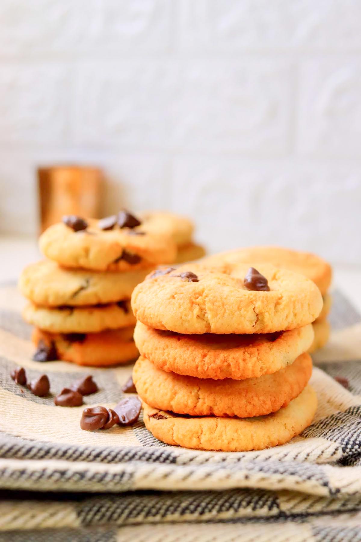 Cookies stacked on a kitchen towel.