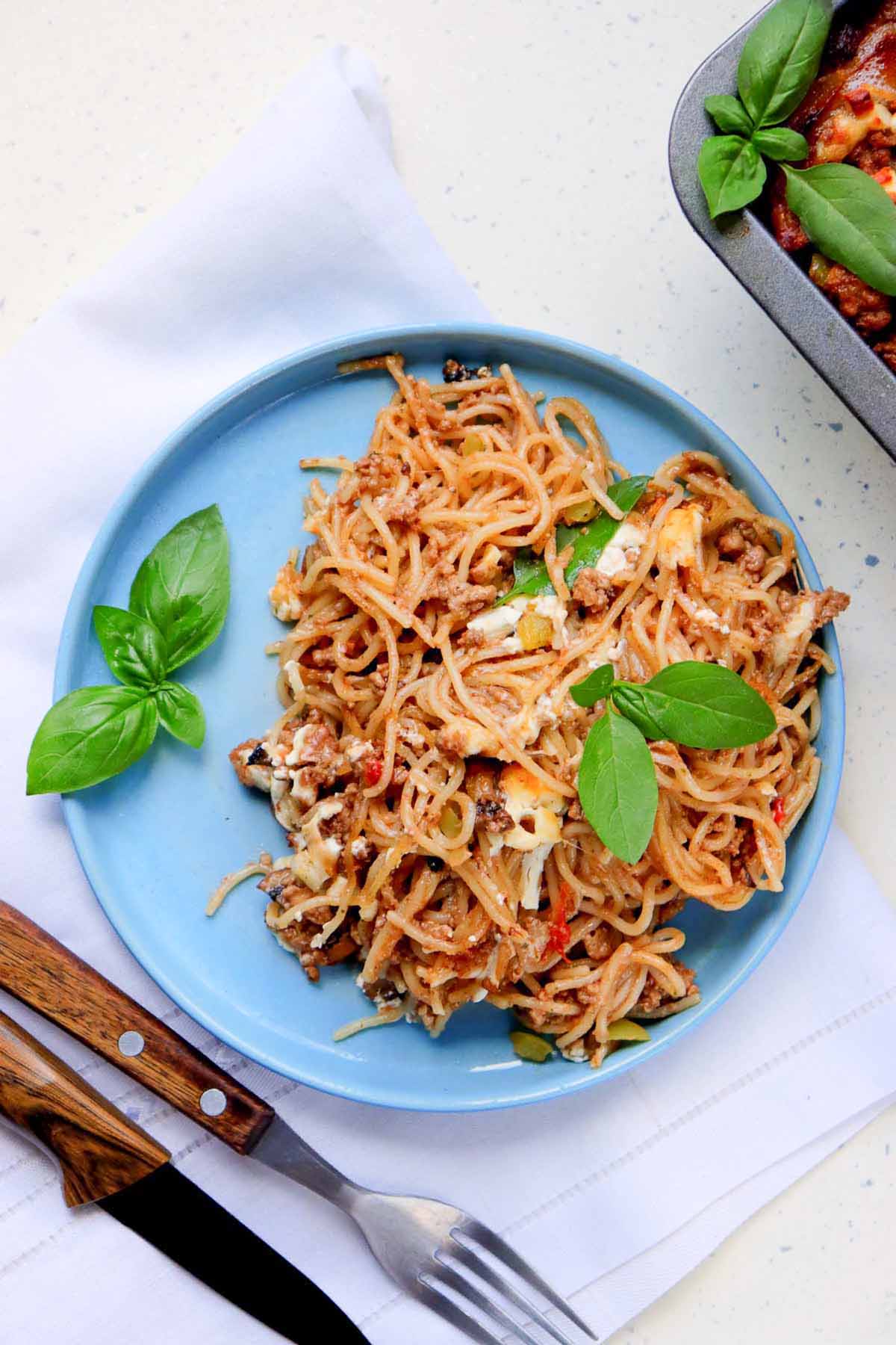 Spaghetti on a blue plate.