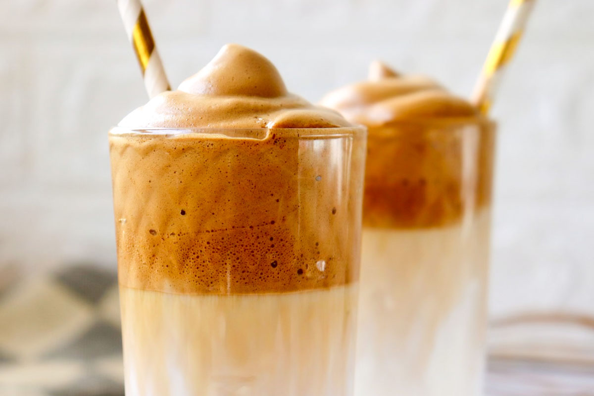 Whipped coffee in a glass with a straw.