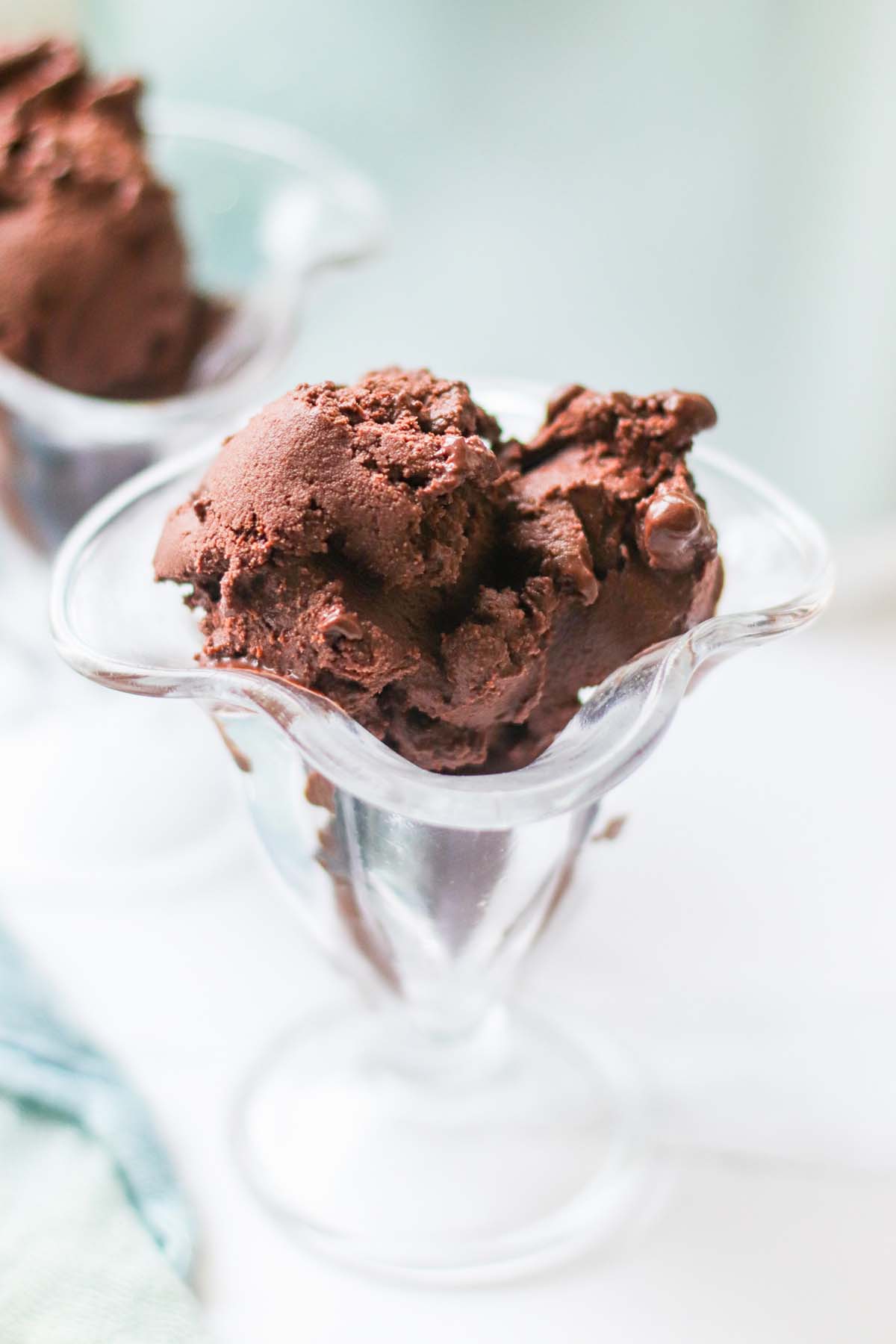 Scoops of chocolate sorbet in a glass dish.