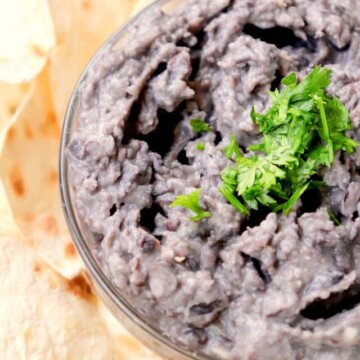 black bean hummus in a bowl topped with cilantro.