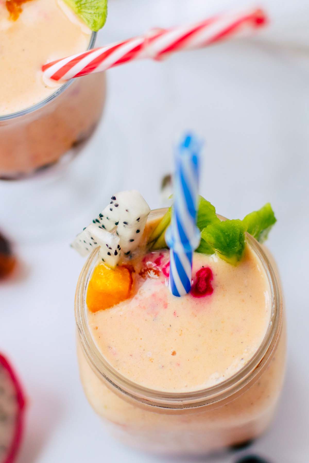top view of pink drink in a glass with a straw.