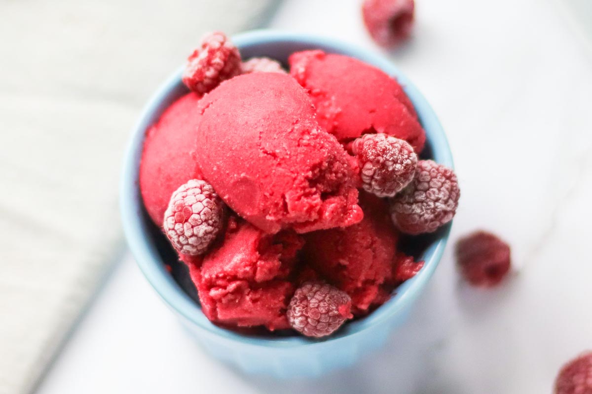 Sorbet topped with frozen raspberries.