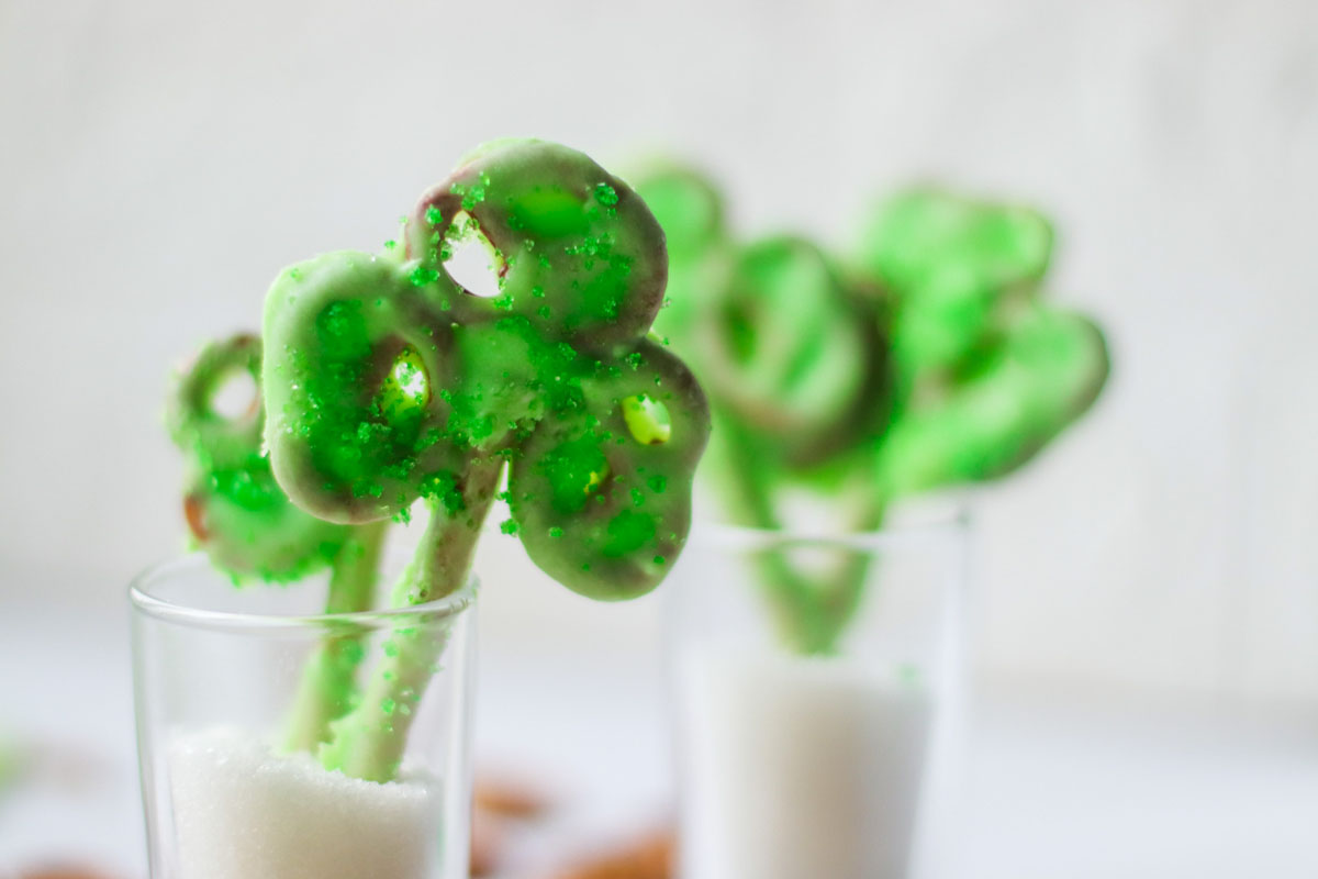 Shamrock pretzel in a glass.