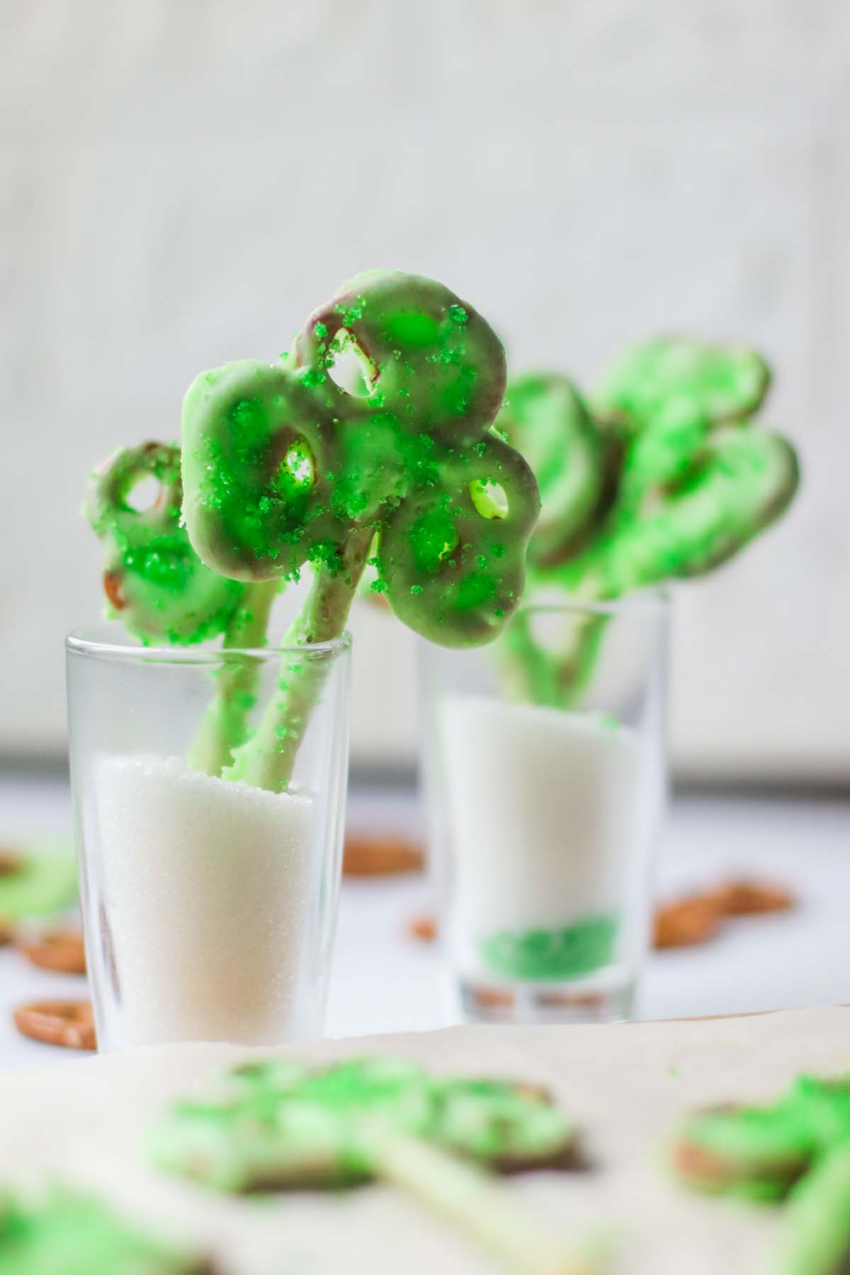 Shamrock pretzels standing in a glass.