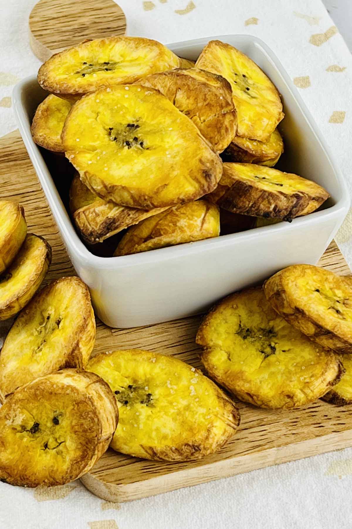 plantains in a bowl on a cutting board.