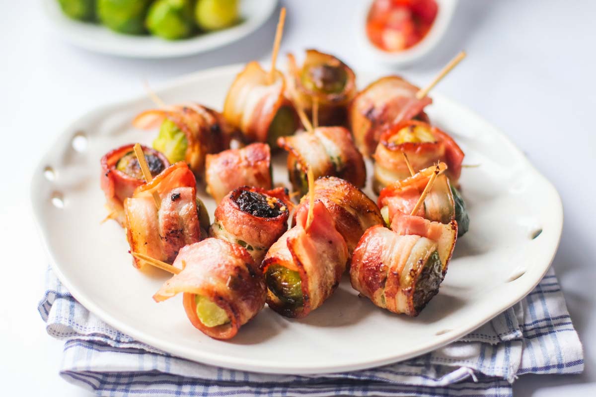 bacon Brussels sprouts on a white plate.