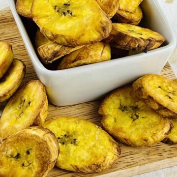 plantains in a bowl on a cutting board.