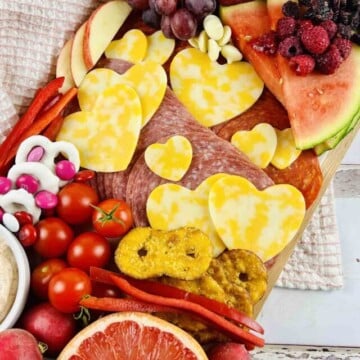 Charcuterie board set on a kitchen towel.