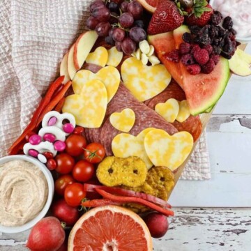 Valentines charcuterie board loaded with meat, cheese and veggies.