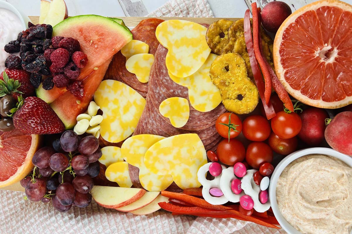 Heart shaped cheese on a charcuterie board.