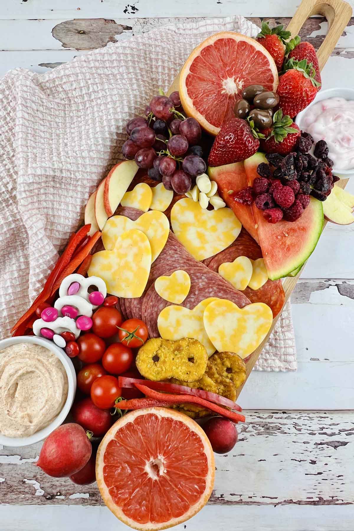 Charcuterie board loaded with meat, cheese and veggies.