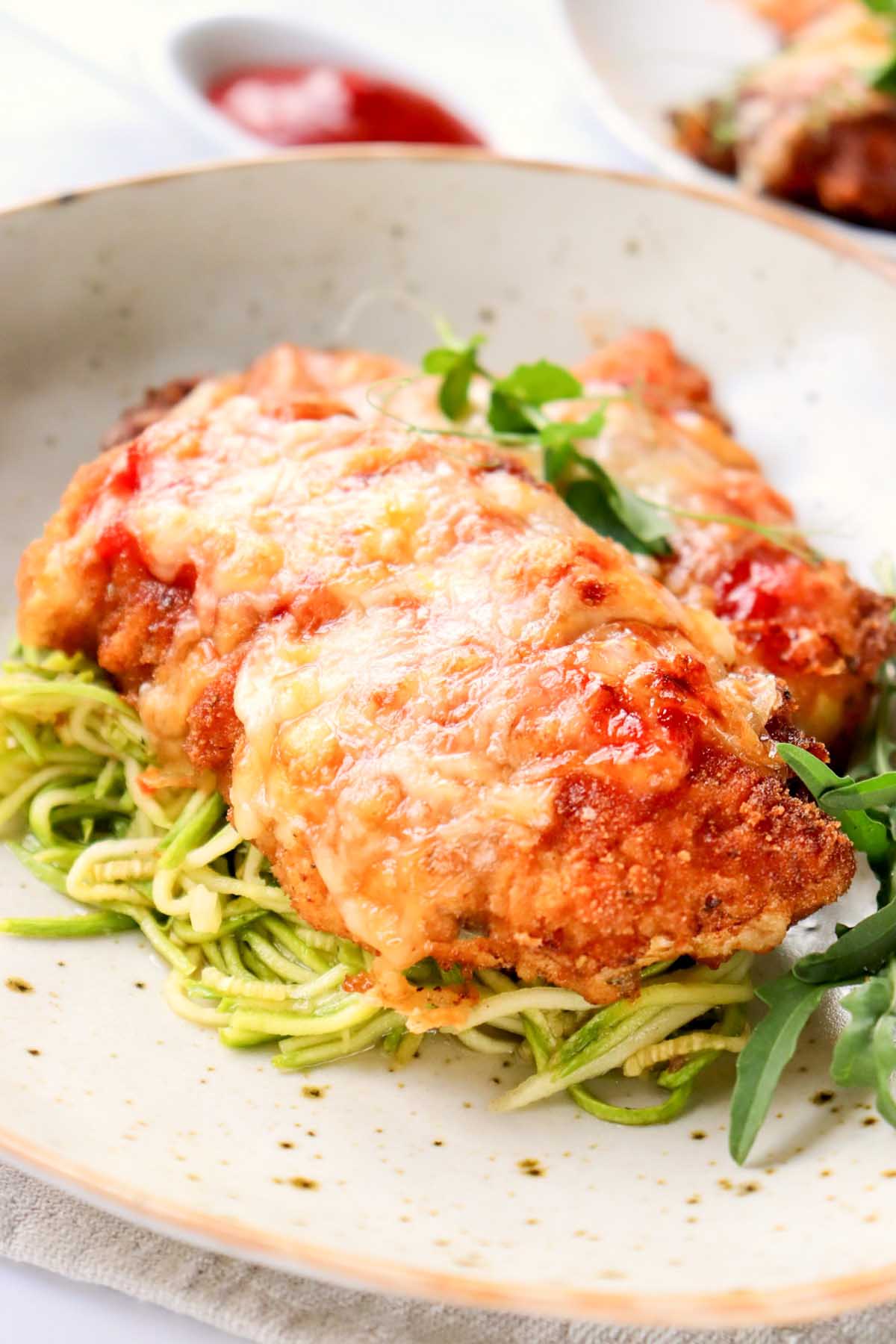 Chicken breast on zucchini noodles.