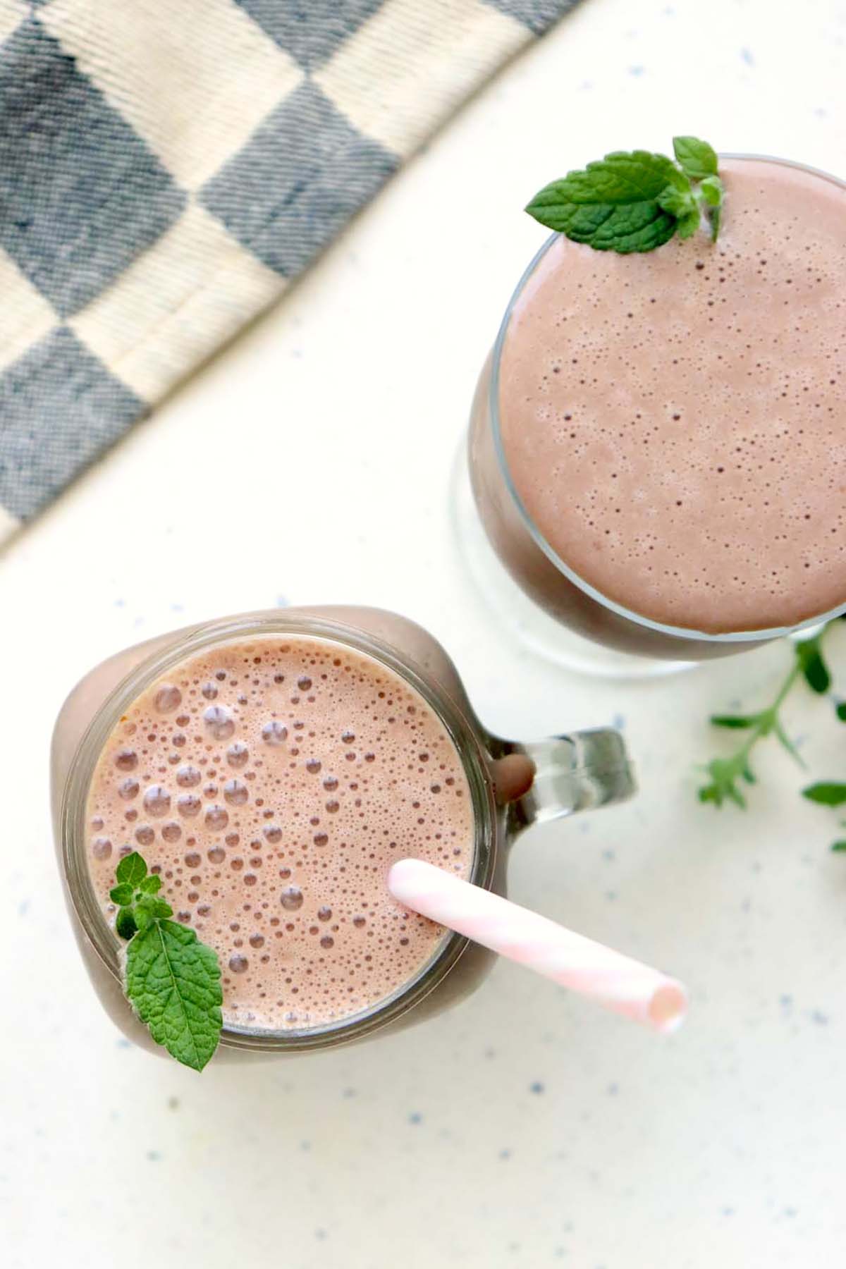 Two glasses of chocolate shakes.