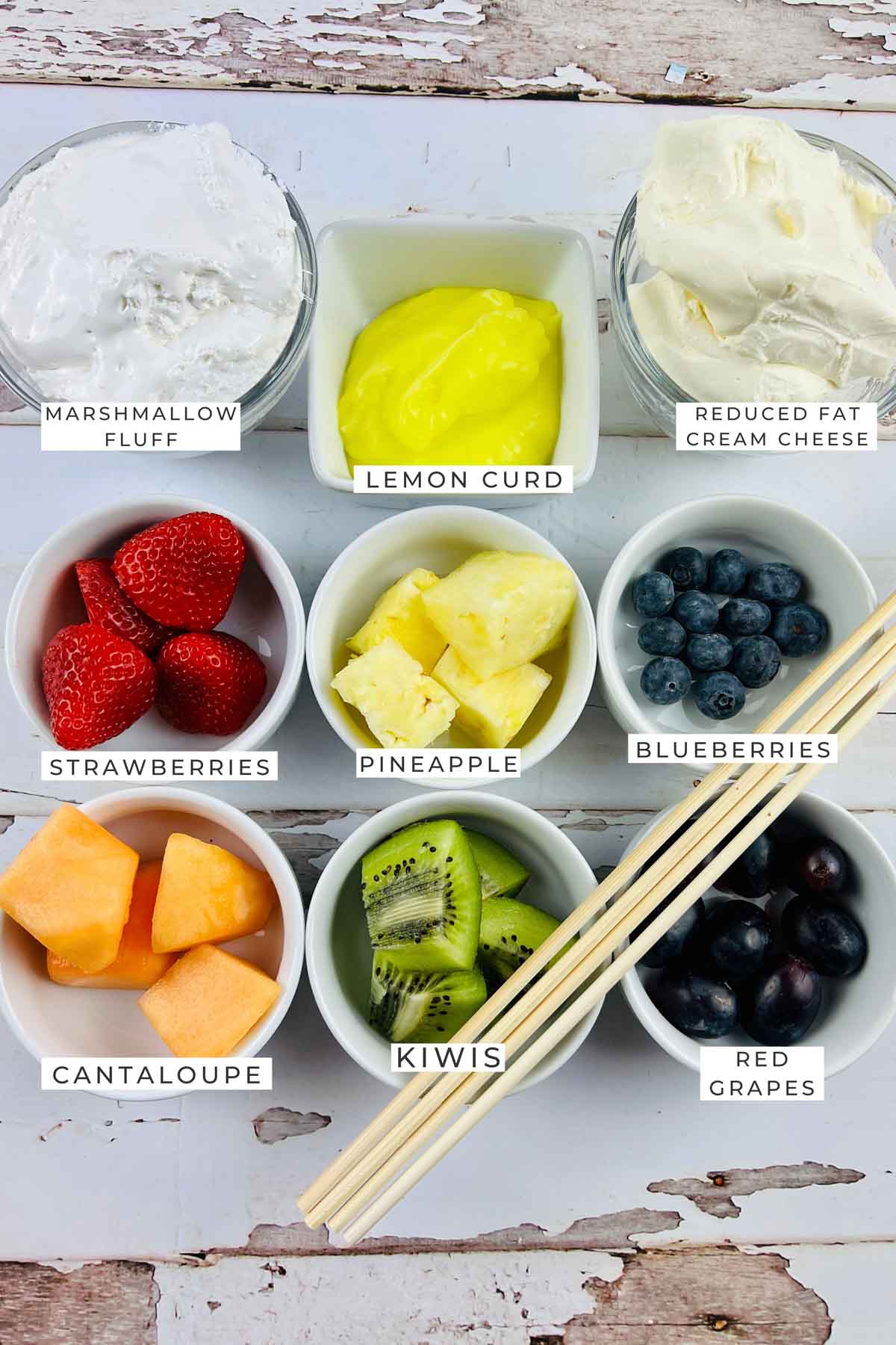 Labeled ingredients for the fruit skewers.