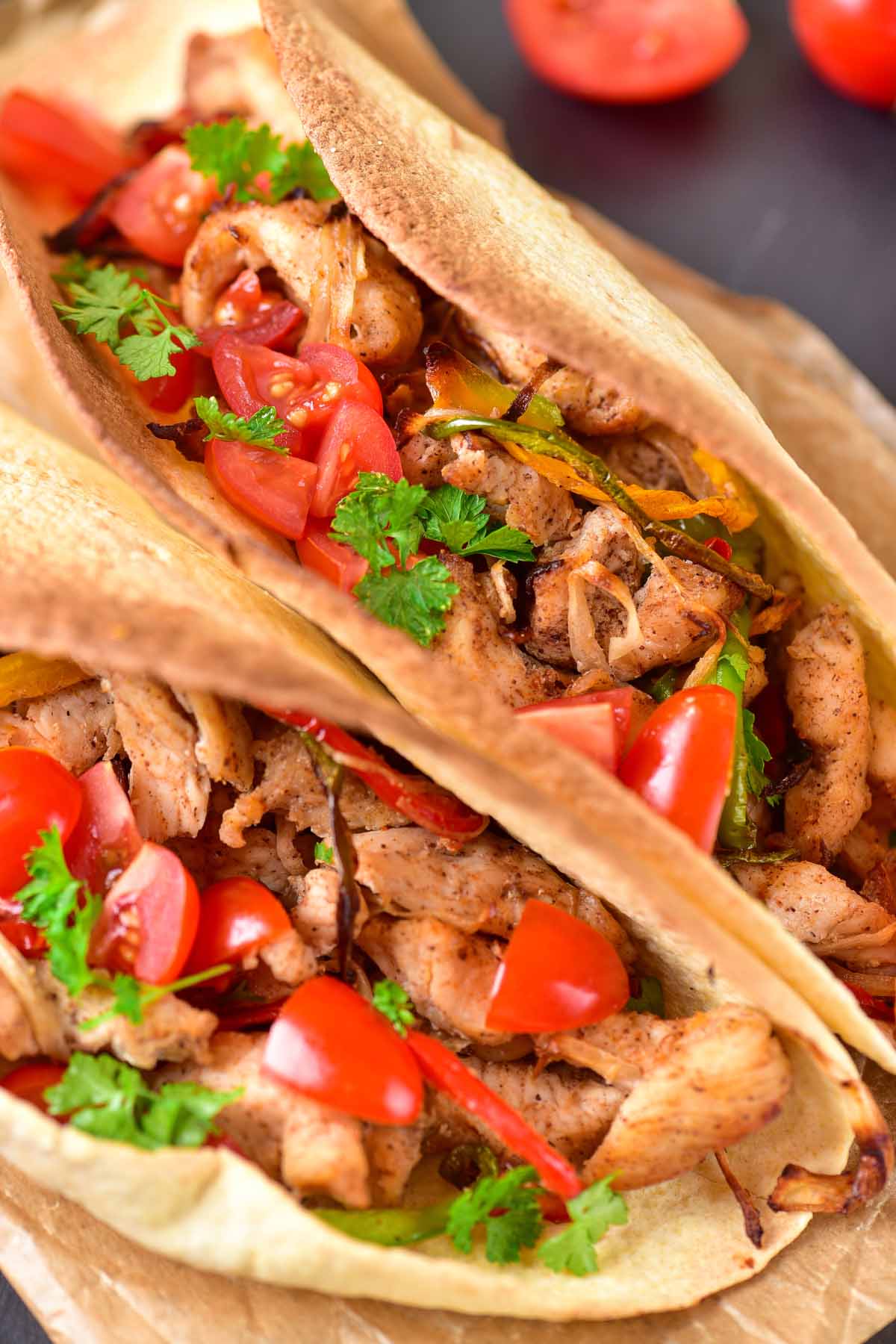 Fajita tacos on parchment paper.