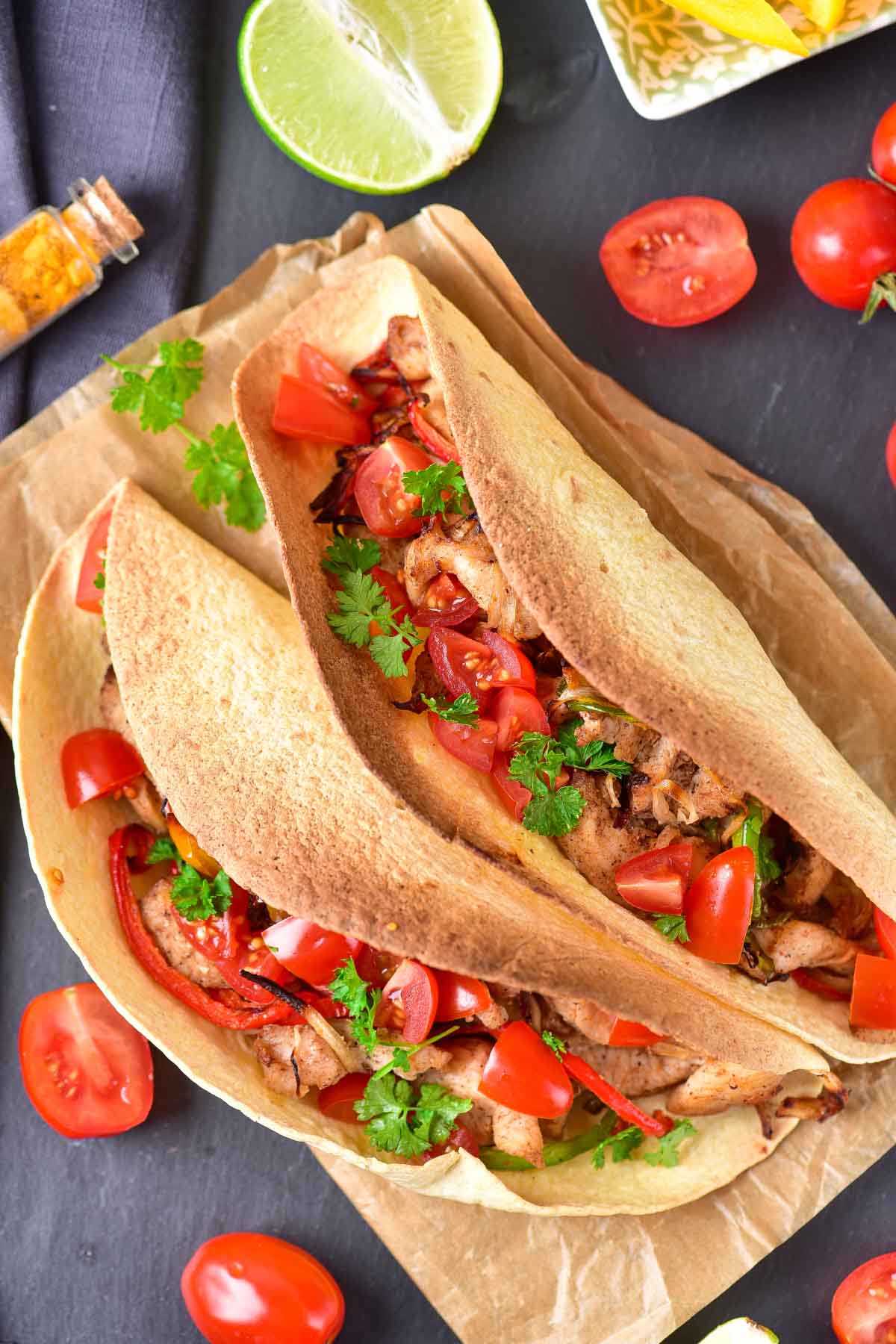 Two fajita tacos on parchment paper.