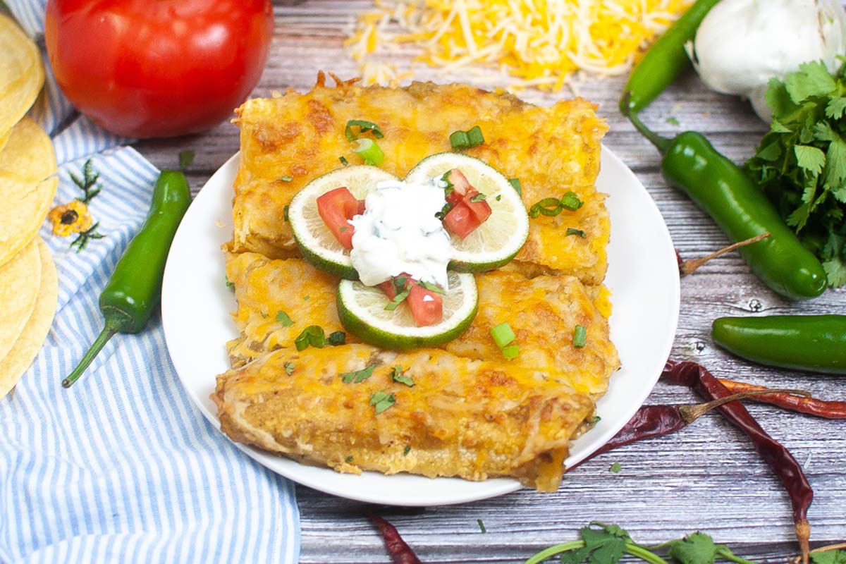 Four enchiladas on a plate.