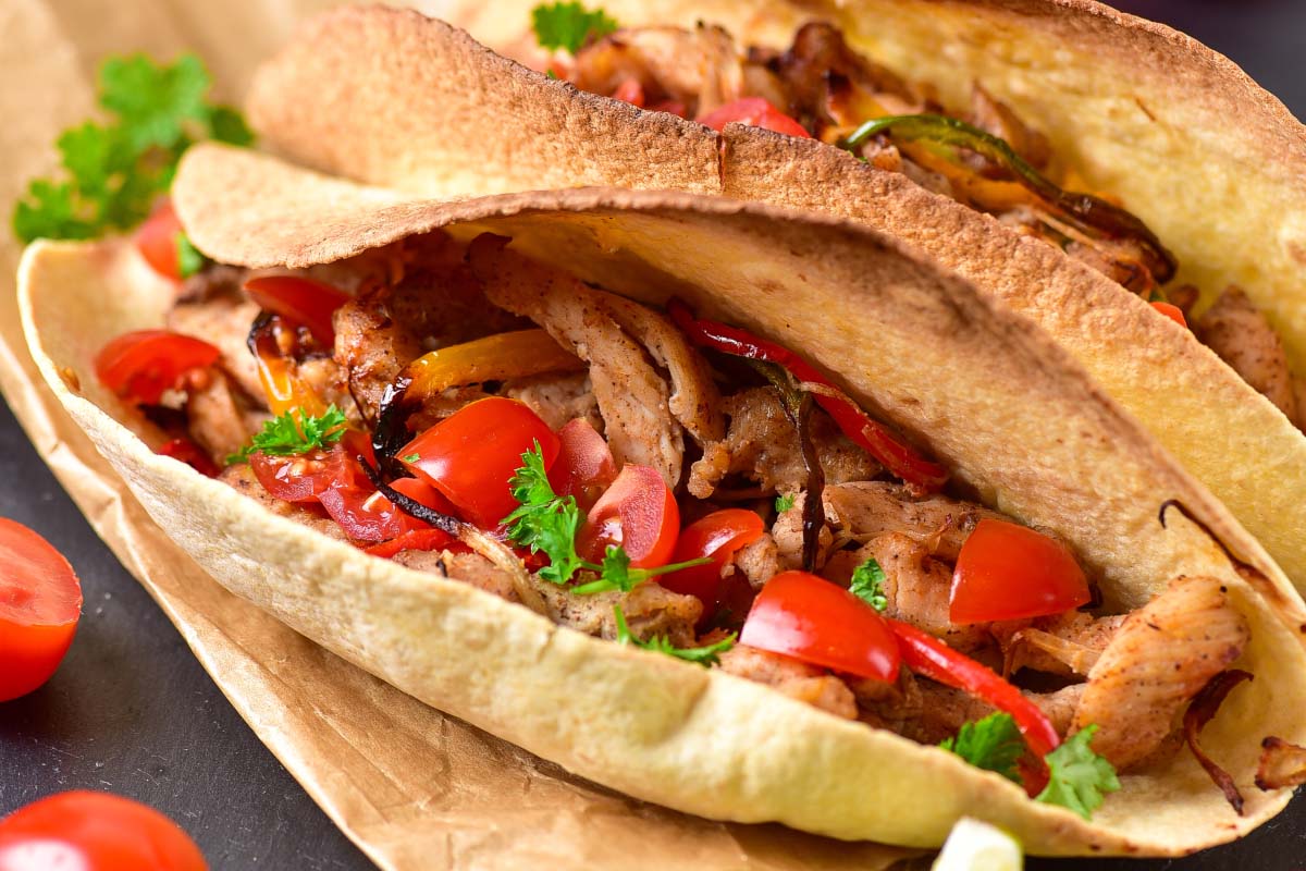 close up view of fajitas in a tortilla.