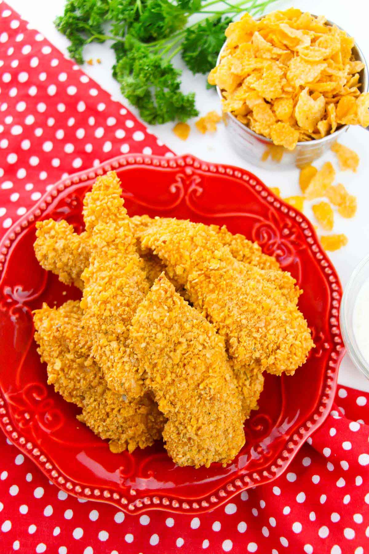 Chicken tenders on a red plate.