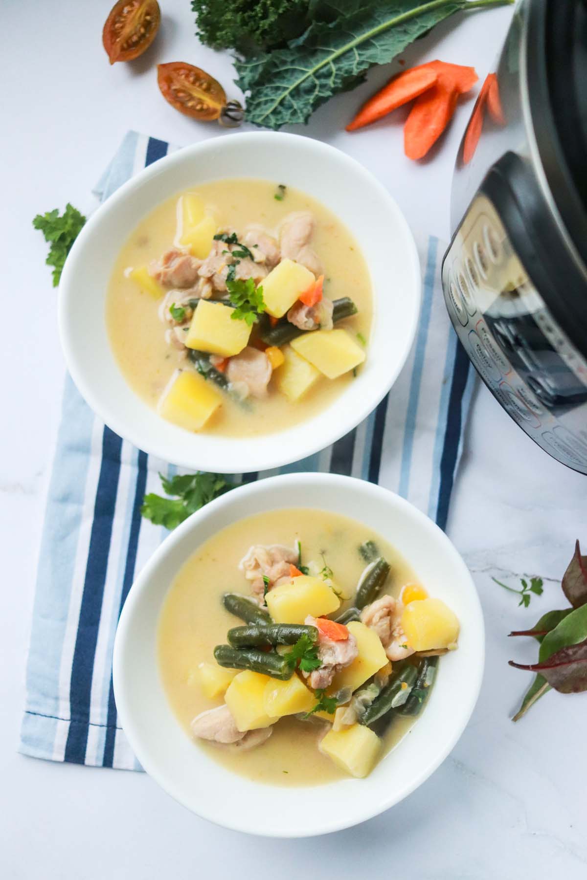 top view of two bowls of soup on a kitchen towel.