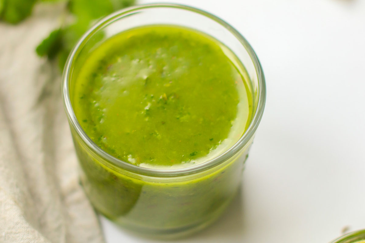 Chimichurri sauce in a glass jar.