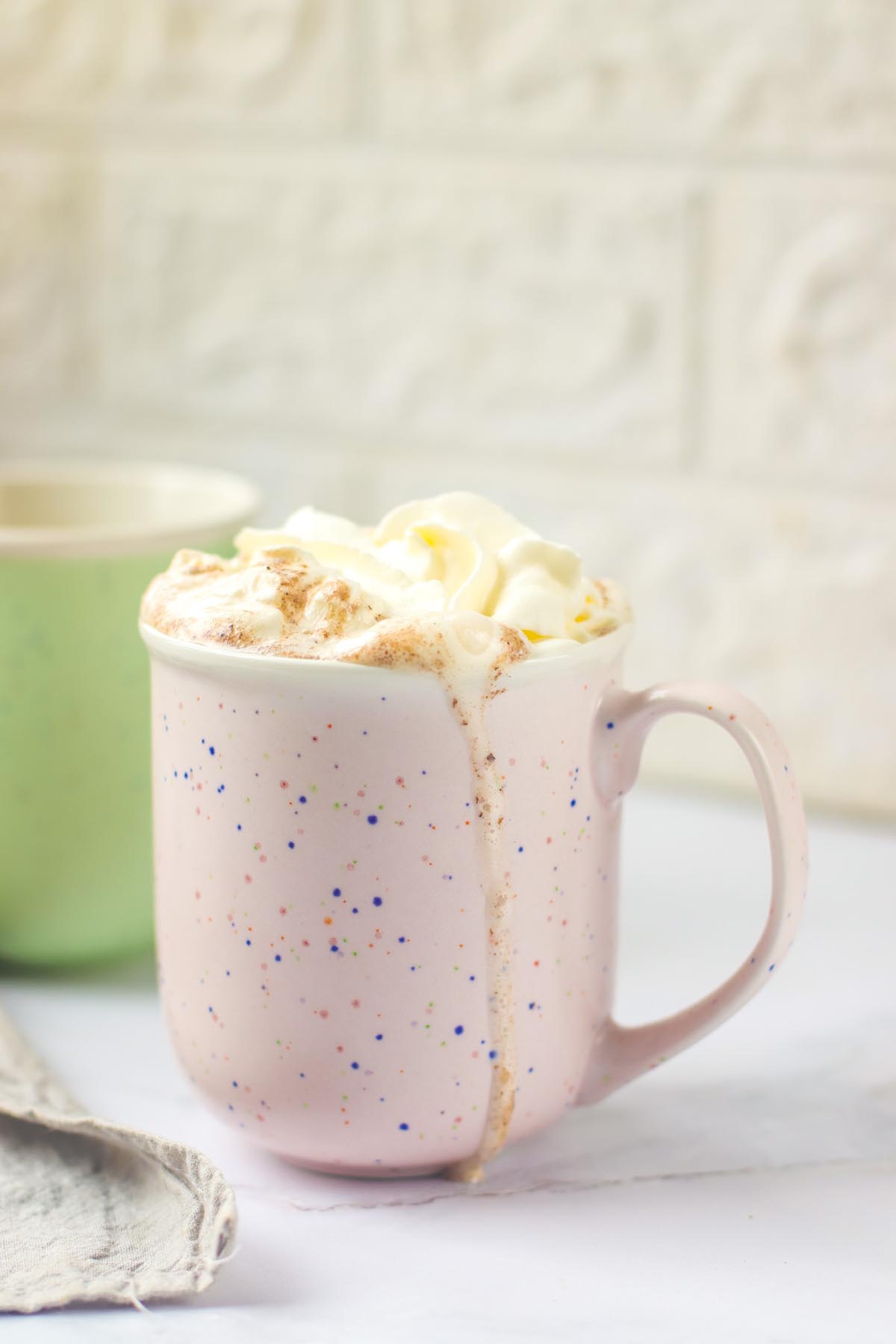 side view mug with whipped cream on top.