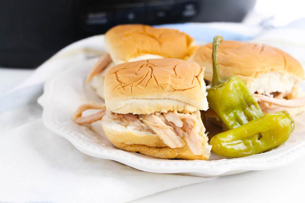 Chicken sandwiches on a white plate.