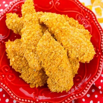 top view of chicken tenders on a red plate.