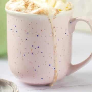 side view mug with whipped cream on top.