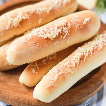 side view of breadsticks on a platter.