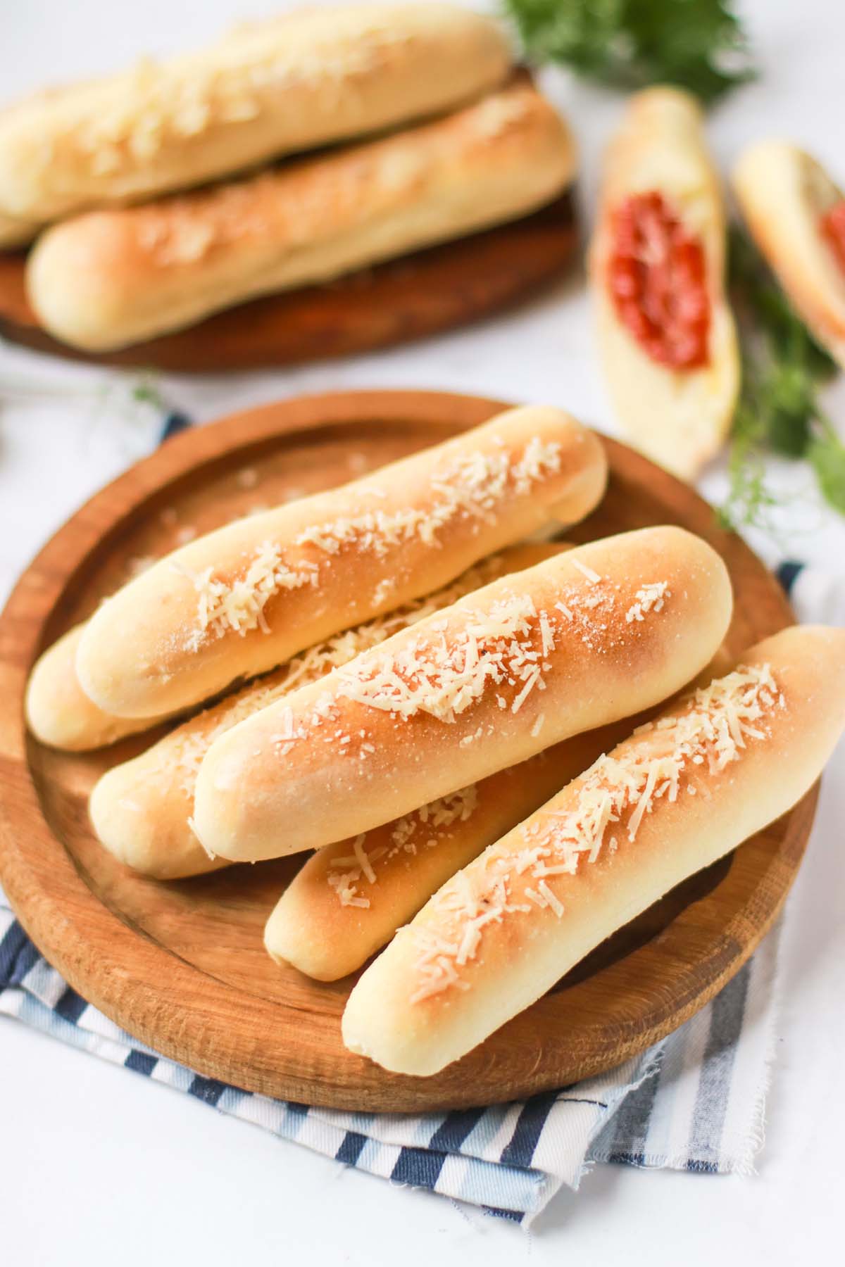 Breadsticks with parmesan cheese on a platter.