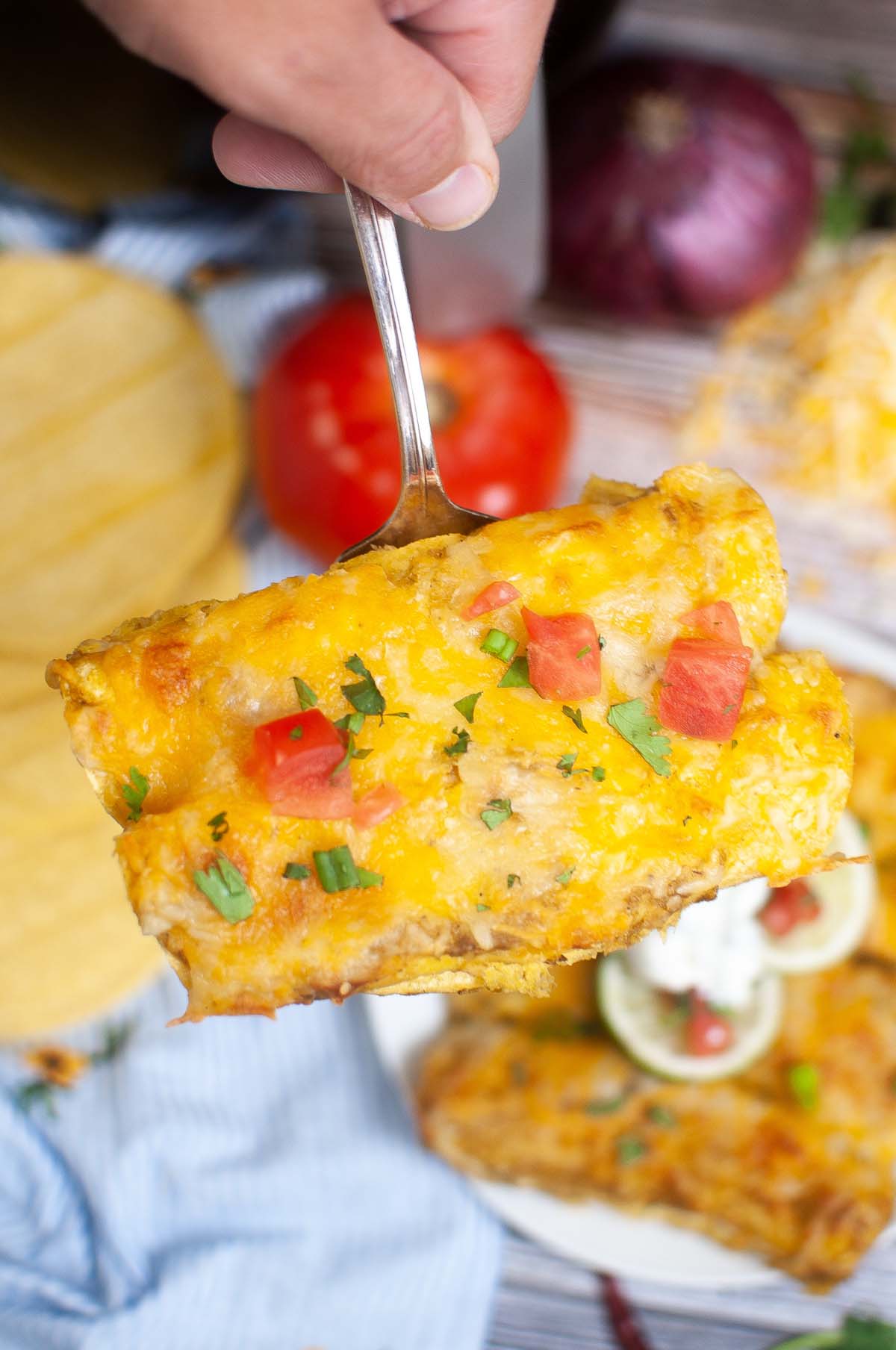 Two enchiladas on a spatula.