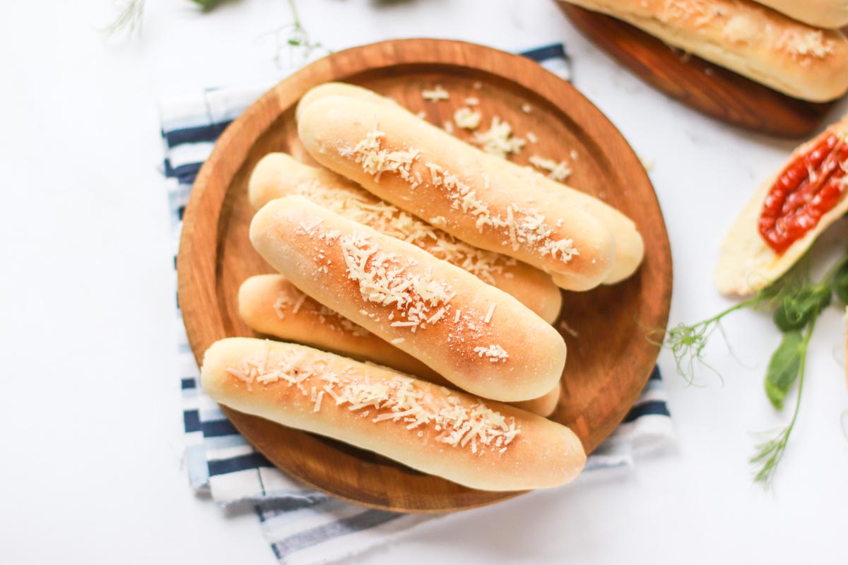 Breadsticks topped with parmesan cheese.