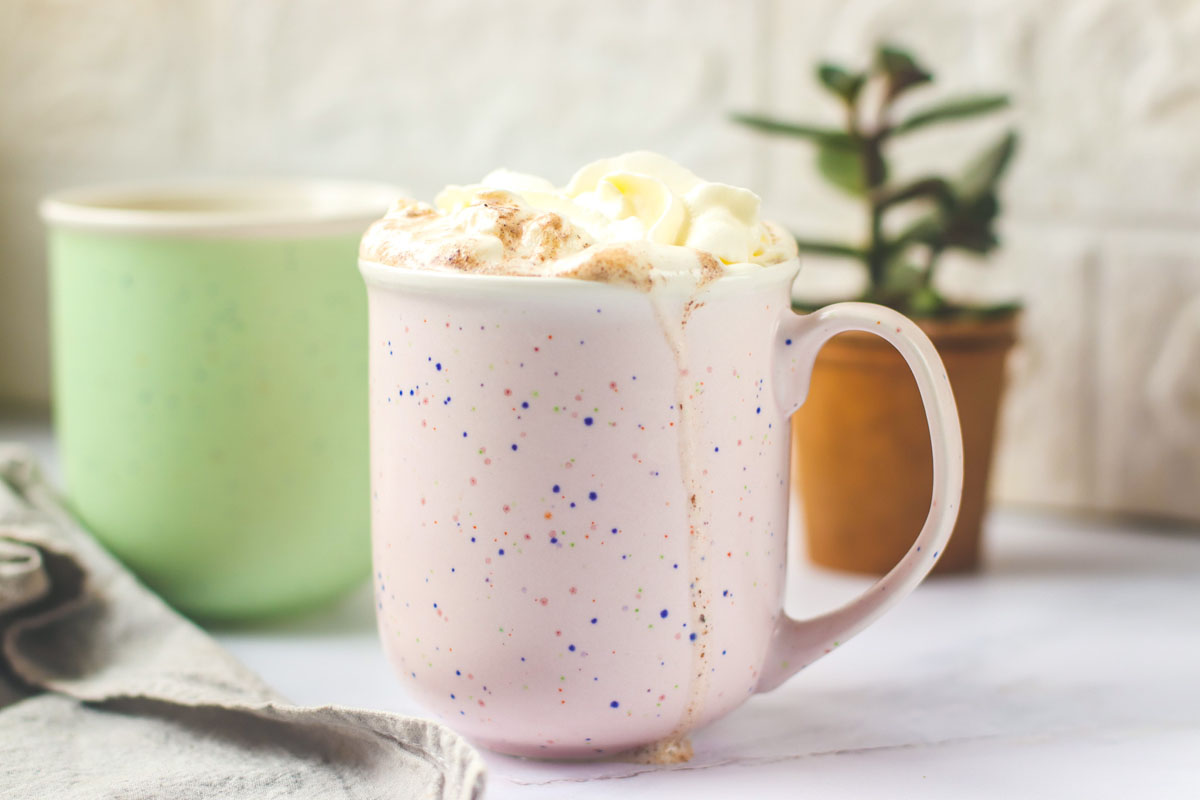 whipped cream in a pink mug.