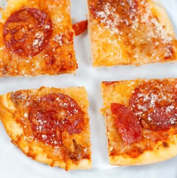pepperoni pizza on a clear plate.