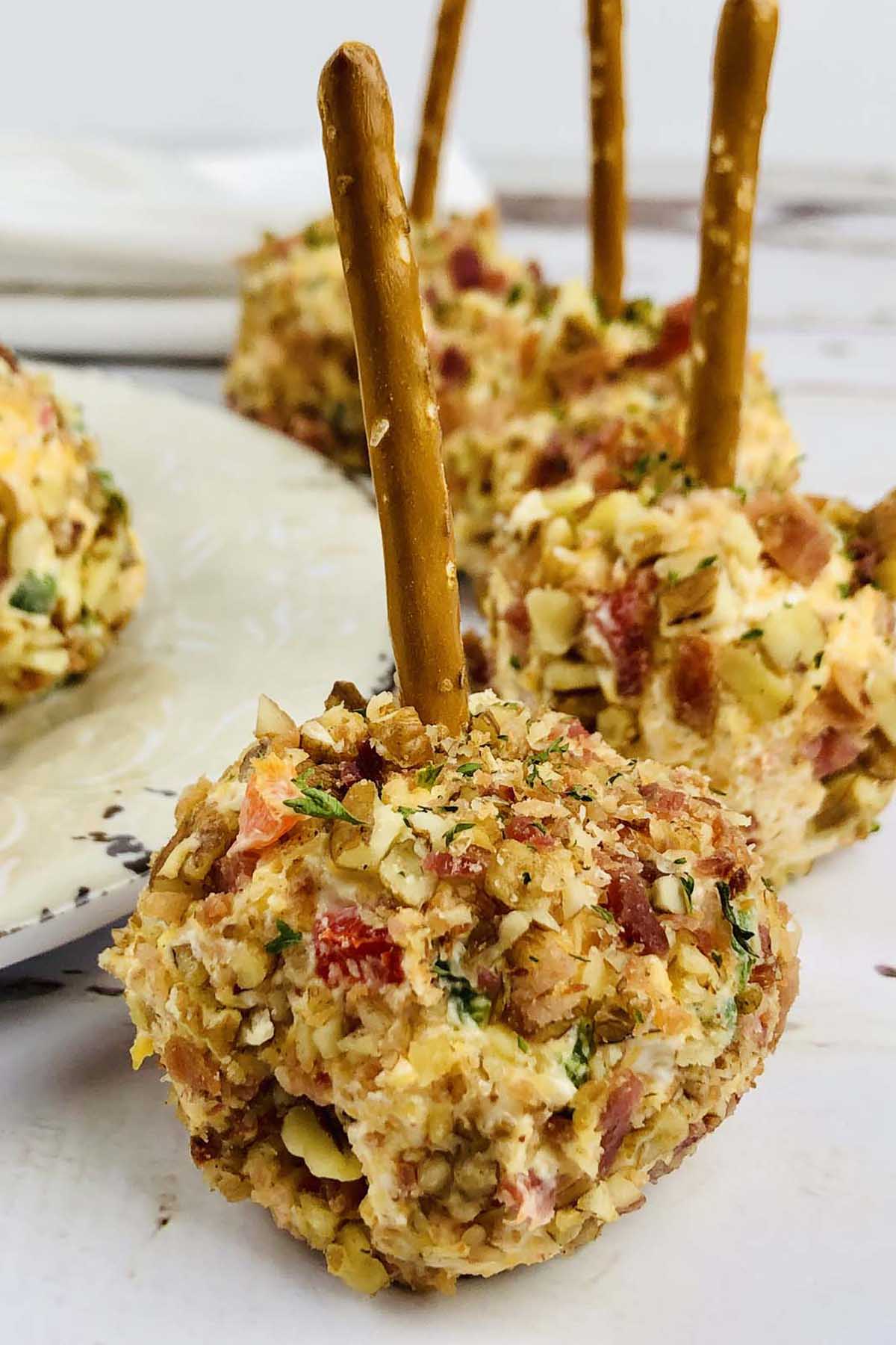 Cheese balls with pretzel sticks stuck in them.