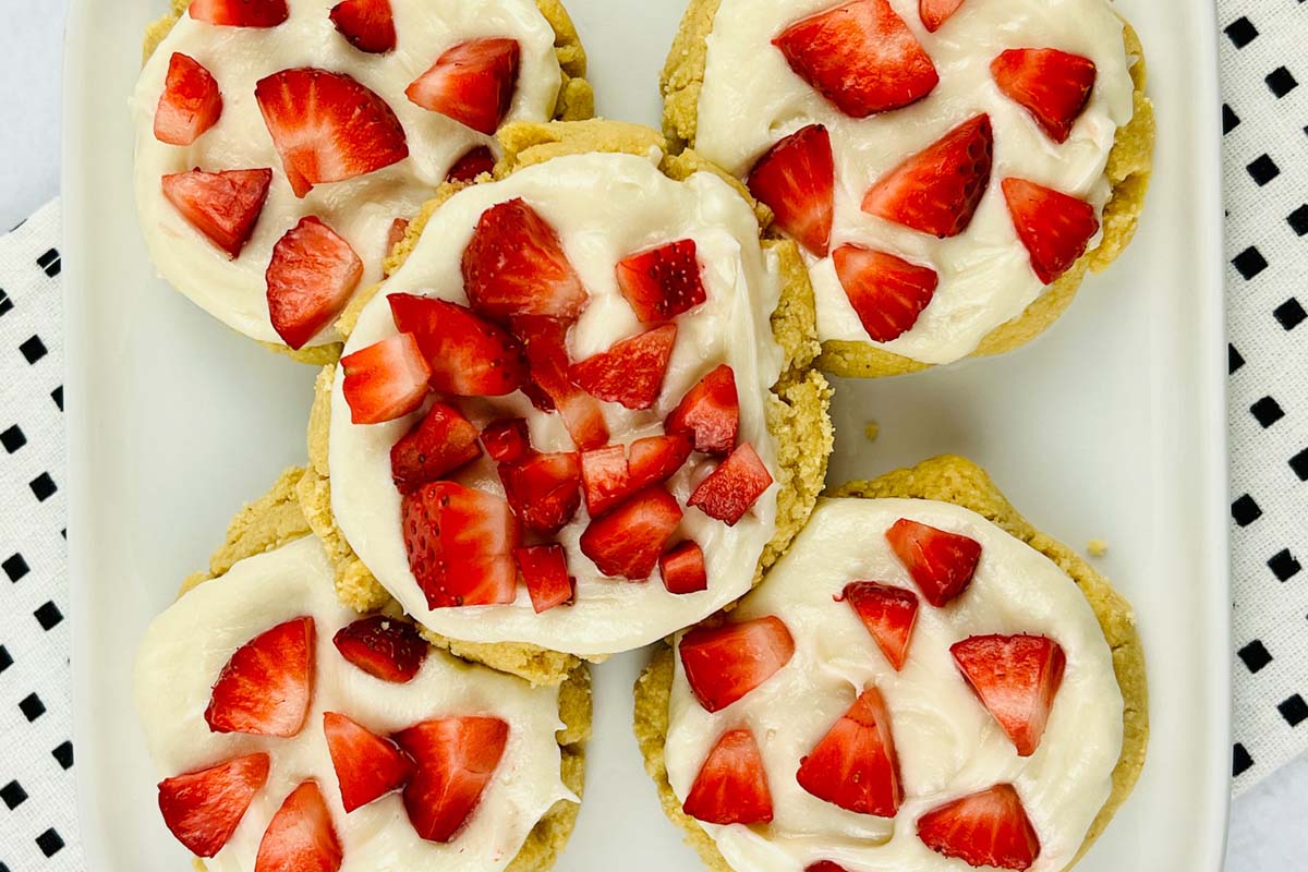 Sugar cookies stacked on a white plate.