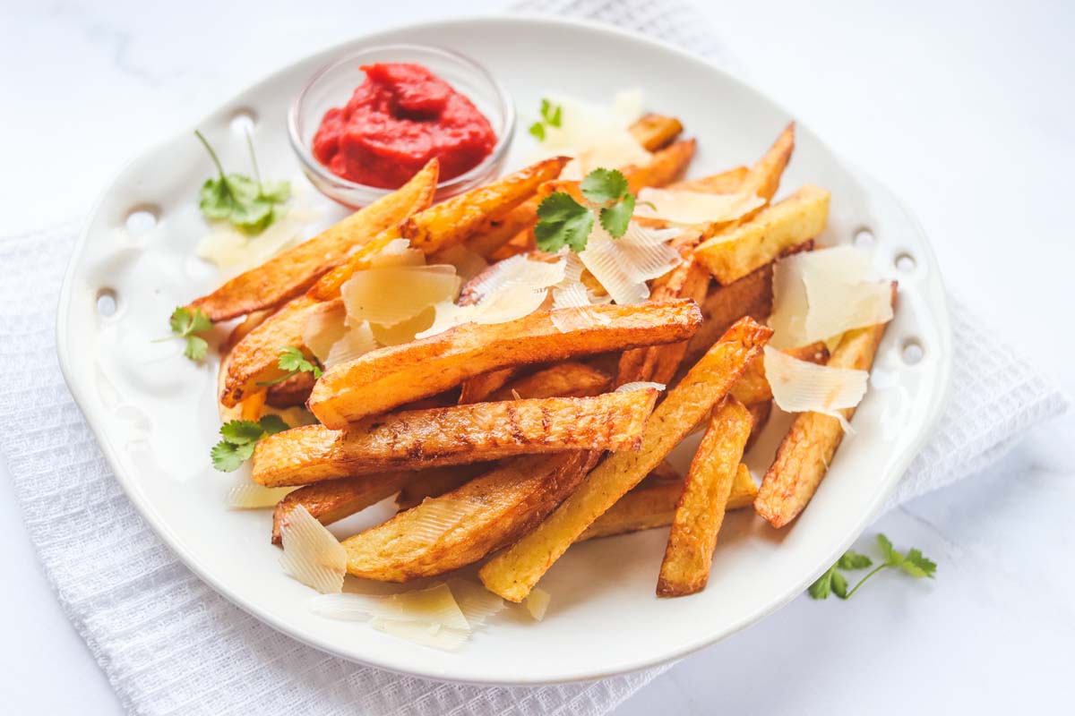 Truffle fries on a white plate.