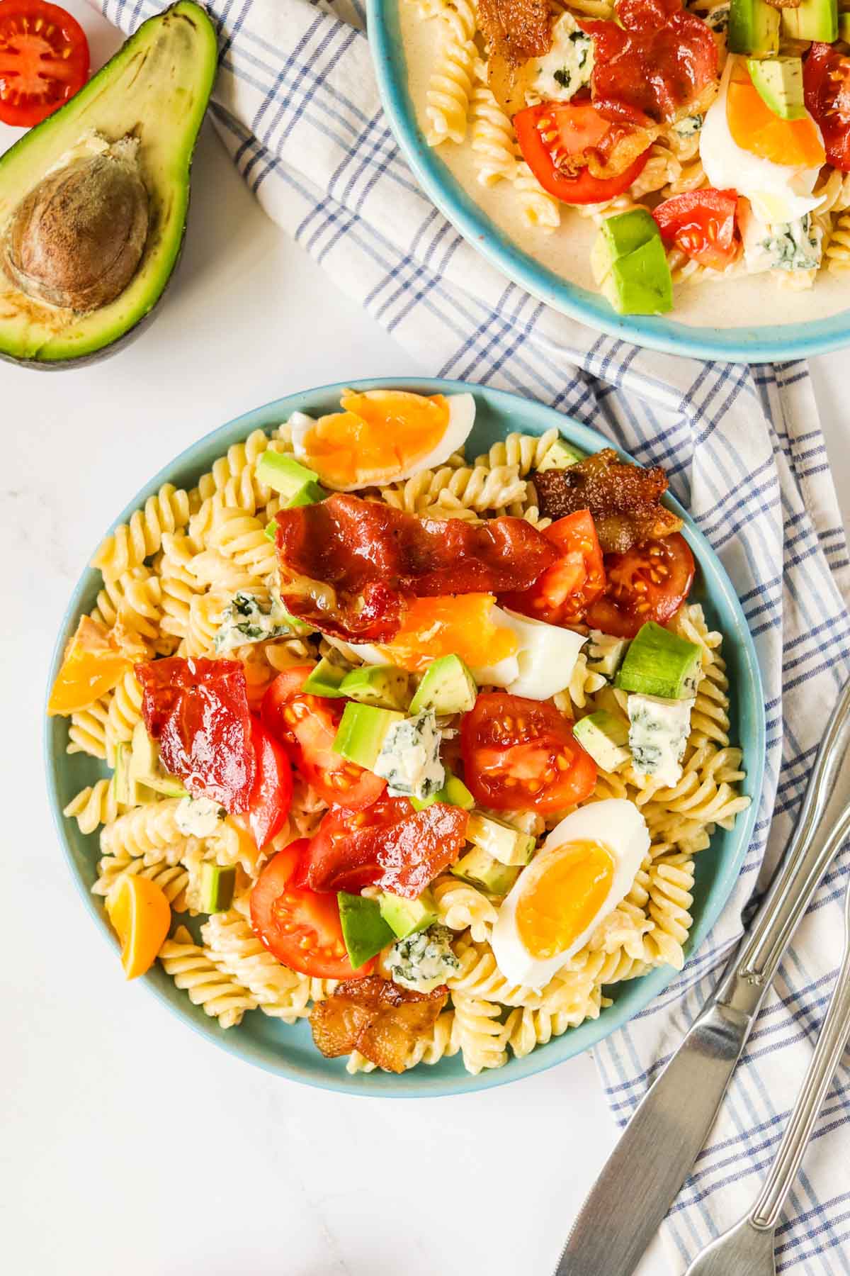 Pasta salad on a blue plate.