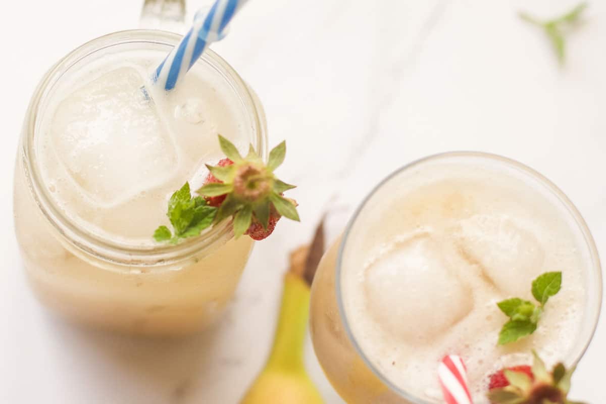 Two glasses of juice with ice.