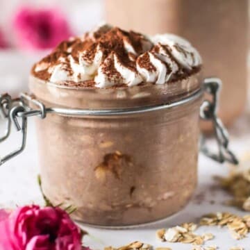 Overnight oats in a jar with whipped cream on top.