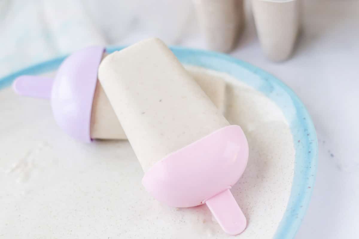 Popsicles on a plate with a blue rim.